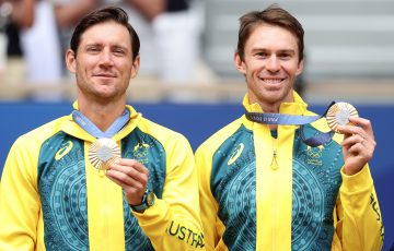 PARIS, FRANCE - AUGUST 03: Gold medallists Matthew Ebden and John Peers of Team Australia celebrate on the podium during the Tennis Men's Doubles medal ceremony after the Tennis Men's Doubles matches on day eight of the Olympic Games Paris 2024 at Roland Garros on August 03, 2024 in Paris, France. (Photo by Matthew Stockman/Getty Images)