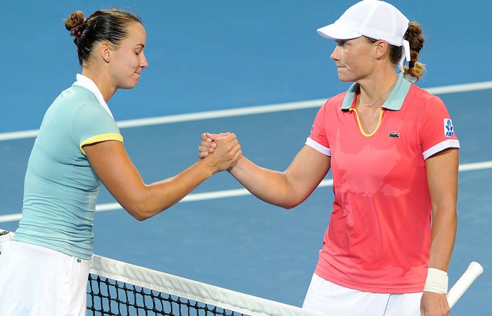 Jarmila Groth shakes hands with compatriot Sam Stosur after winning their second round match at the Brisbane International. AFP PHOTO/William WEST 