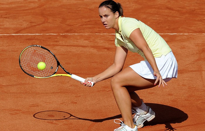 Australian player Jarmila Groth hits a volley during Fed Cup against Ukraine. Getty Images