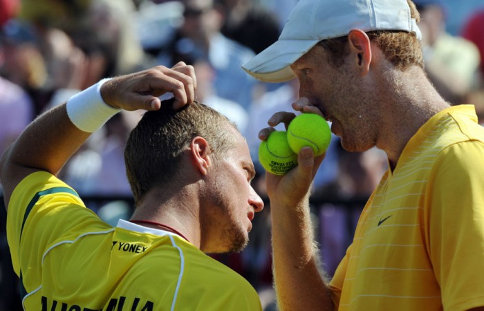 Chris Guccione (right) whispers to Lleyton Hewitt. AFP