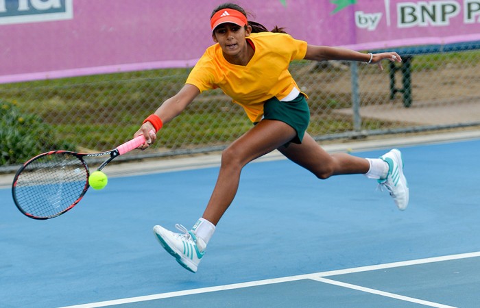 Naiktha Bains runs for a forehand during her win against Malaysia's Choo Lyn Yuen in Australia's second match of their Junior Fed Cup qualifying campaign; Bill Conroy