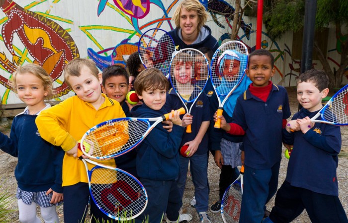 Essendon footballer Dyson Heppell with students from Stonnington Primary School. MARK RIEDY