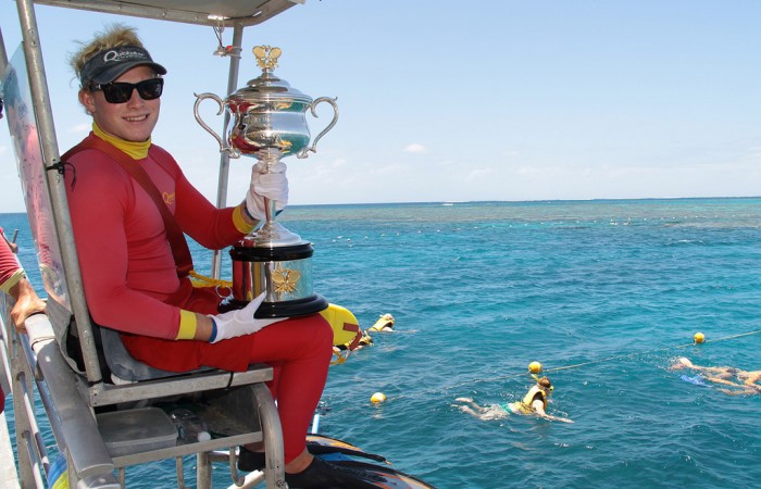 The Daphne Akhurst Memorial Cup is held by a scuba diver as part of the Australian Open Trophy Tour on the Agincourt Reef on the outer edge of the Great Barrier Reef in Queensland; Tennis Australia 