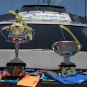 The Norman Brookes Challenge Cup (R) and the Daphne Akhurst Memorial Cup all kitted up aboard the Quicksilver high-speed wave-piercing catamaran for their Great Barrier Reef tour; Tennis Australia
