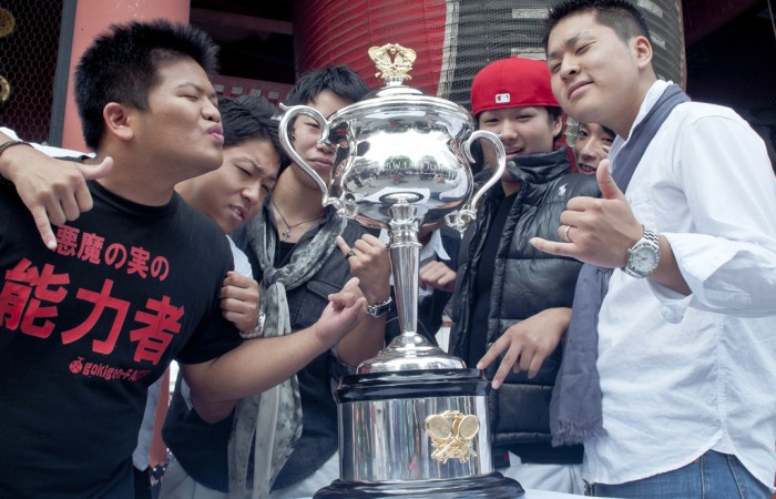 Fans pose with the Daphne Akhust Memorial Cup in Tokyo as part of the AO Trophy Tour; Keith Tsuji