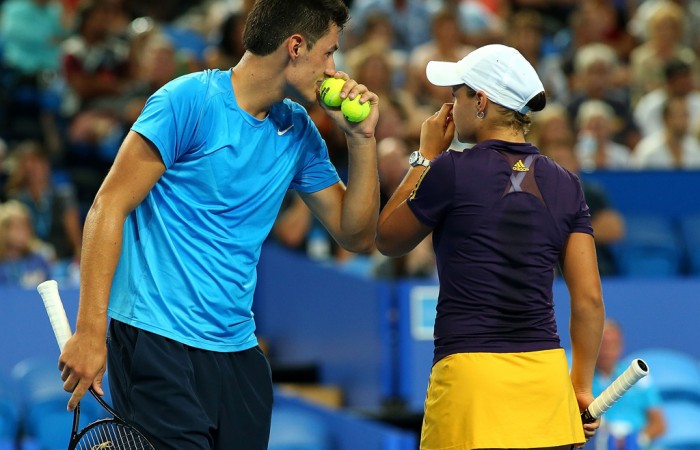 Aussies Bernard Tomic and Ashleigh Barty discuss tactics during their mixed doubles match against Novak Djokovic and Ana Ivanovic of Serbia, which they ultimately lost in an exciting third-set match tiebreak; Getty Images