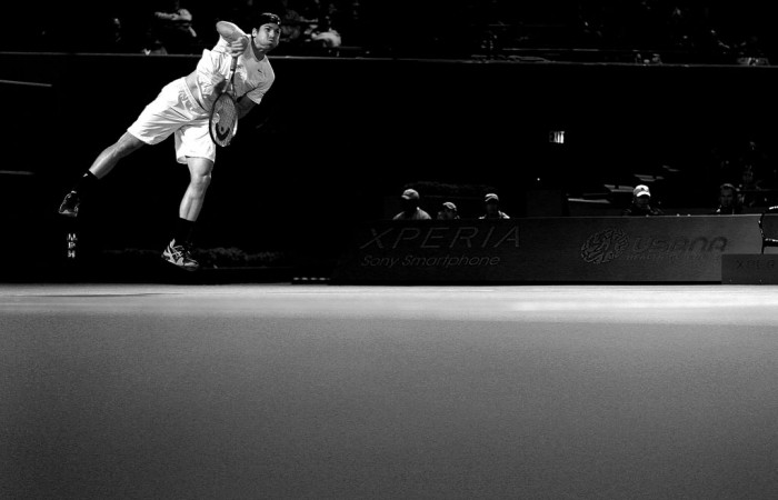 In this converted black-and-white image, Tommy Haas serves to Gilles Simon during his straight-set quarterfinal victory at the Sony Open in Key Biscayne, Florida; Getty Images