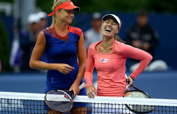 Daniela Hantuchova (L) and the recently-returned Martina Hingis share a laugh after their first round doubles victory at the WTA Rogers Cup in Toronto; Getty Images