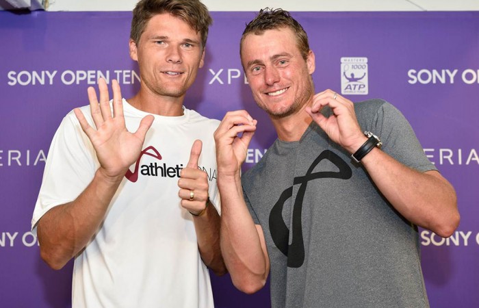 Lleyton Hewitt (R) and former Australian pro Peter Luczak celebrate Hewitt's 600th career victory following his first round defeat of Robin Haase at the Sony Open in Miami; Peter Staples/Sony Open Tennis