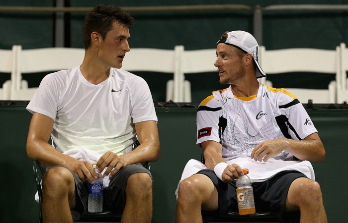 Bernard Tomic (L) and Lleyton Hewitt play doubles at the Miami Open in 2013; Getty Images