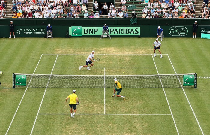 Bob and Mike Bryan (top) and Lleyton Hewitt and John Peers (bottom) in action during the doubles rubber of the Australia v United States Davis Cup World Group tie at Kooyong Lawn Tennis Club; Getty Images