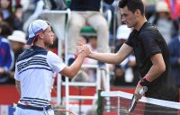 Bernard Tomic (R) shakes hands with Diego Schwartzman after the Argentine won their second-round match in Tokyo; Getty Images