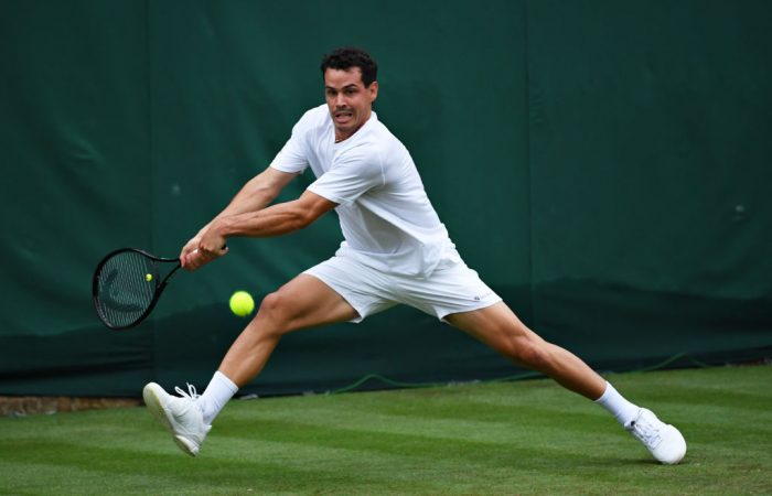 LONDON, ENGLAND - JUNE 29: Alex Bolt of Australia stretches to plays a backhand in his Men's Singles First Round match against Filip Krajinovic of Serbia during Day Two of The Championships - Wimbledon 2021 at All England Lawn Tennis and Croquet Club on June 29, 2021 in London, England. (Photo by Mike Hewitt/Getty Images)