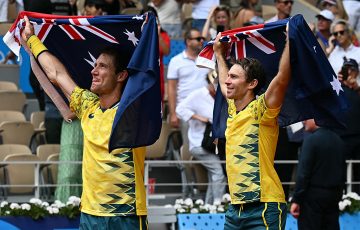 Australia's Matthew Ebden (L) and Australia's John Peers (R) holding Australian flags, celebrate beating US' Austin Krajicek and US' Rajeev Ram during their men's doubles final tennis match on Court Philippe-Chatrier at the Roland-Garros Stadium during the Paris 2024 Olympic Games, in Paris on August 3, 2024. (Photo by PATRICIA DE MELO MOREIRA / AFP) (Photo by PATRICIA DE MELO MOREIRA/AFP via Getty Images)