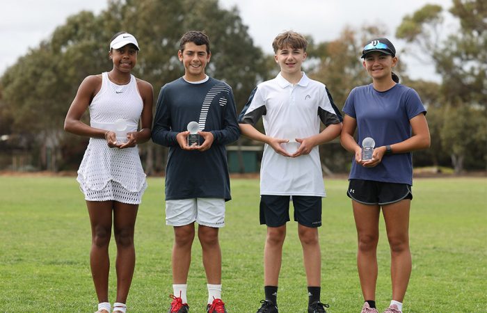 (L-R) 12/u champions Cleo Taylor and Novak Palombo, and 14/u champions Raphael Savelli and Tori Russell, pose with their trophies after winning the 