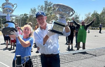 Pomonal Tennis Club president Michelle Stewart and John Fitzgerald with the Australian Open trophies. Photo: Tennis Australia