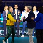 Sam Stosur, captain of Team Australia, receives her Billie Jean King Cup commitment award from David Haggerty and Conchita Martinez before the quarterfinal tie between Australia and Slovakia in Malaga, Spain. [Getty Images]