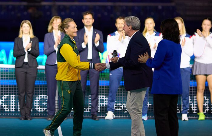 Sam Stosur, captain of Team Australia, receives her Billie Jean King Cup commitment award from David Haggerty and Conchita Martinez before the quarterfinal tie between Australia and Slovakia in Malaga, Spain. [Getty Images]