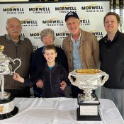 John Fitzgerald and Morwell Tennis Club members pose with the Australian Open trophies. 