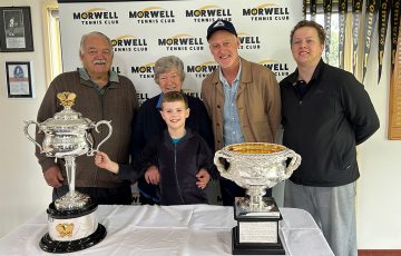 John Fitzgerald and Morwell Tennis Club members pose with the Australian Open trophies. 