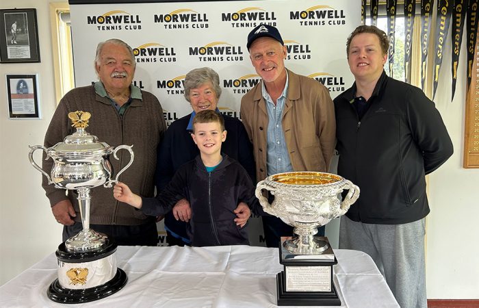 John Fitzgerald and Morwell Tennis Club members pose with the Australian Open trophies. 