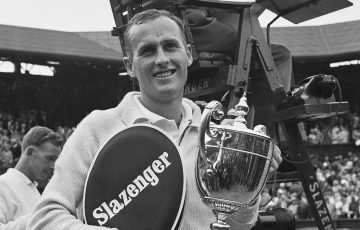 Neale Fraser with the men's singles trophy after beating fellow Australian Rod Laver in the final at the 1960 Wimbledon Championships [Credit: Evening Standard/Hulton Archive/Getty Images]